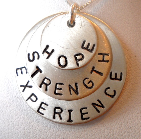 necklace with hope, strength, and experience lettering